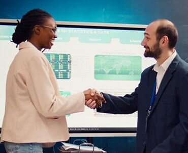 WOMAN AND MAN SHAKING HANDS